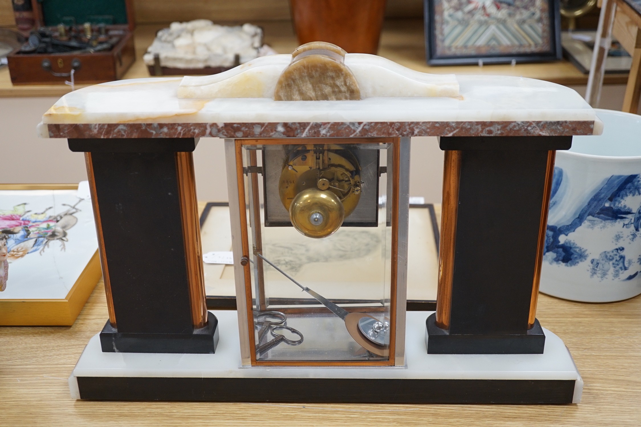 An Art Deco chrome, copper, brass and alabaster four glass mantel clock, 54cms wide